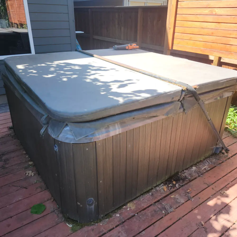 Before: a worn hot tub sitting on a backyard deck in South Salem, OR