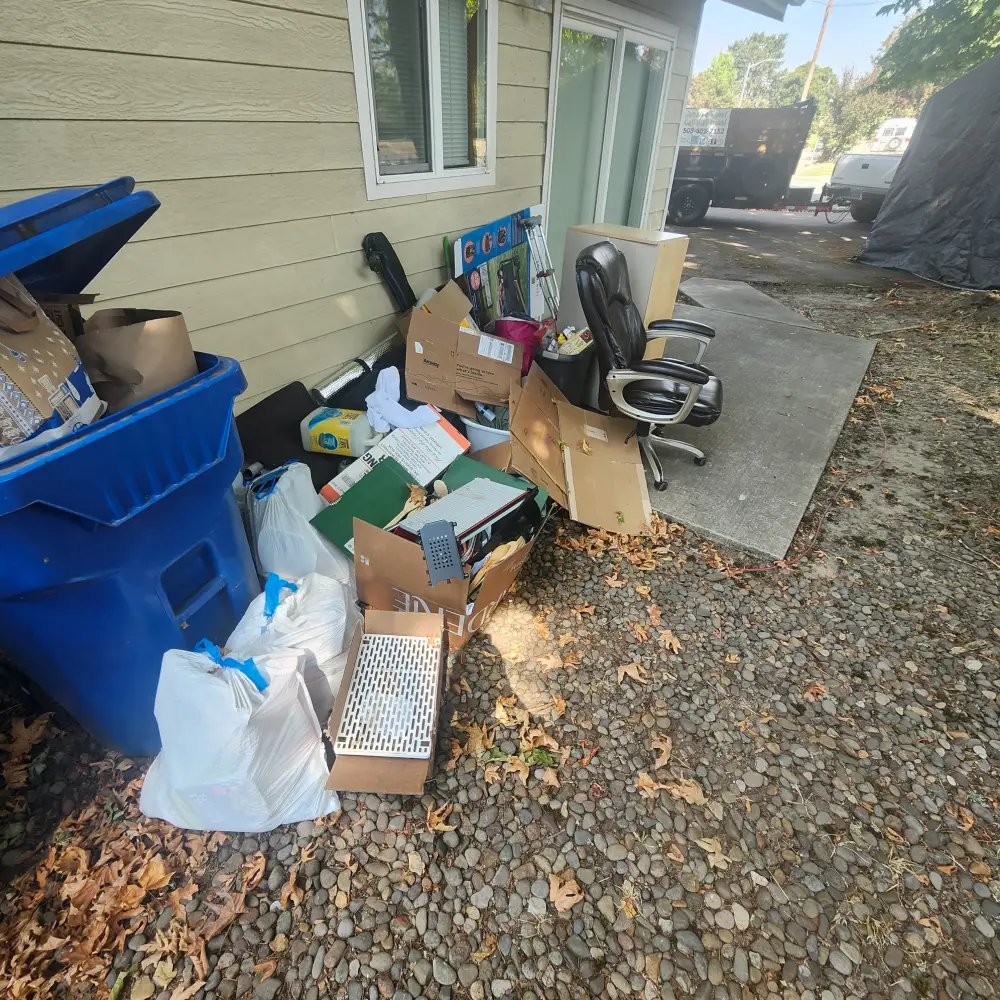 Household junk cleared to the side of a home during a South Salem cleanout