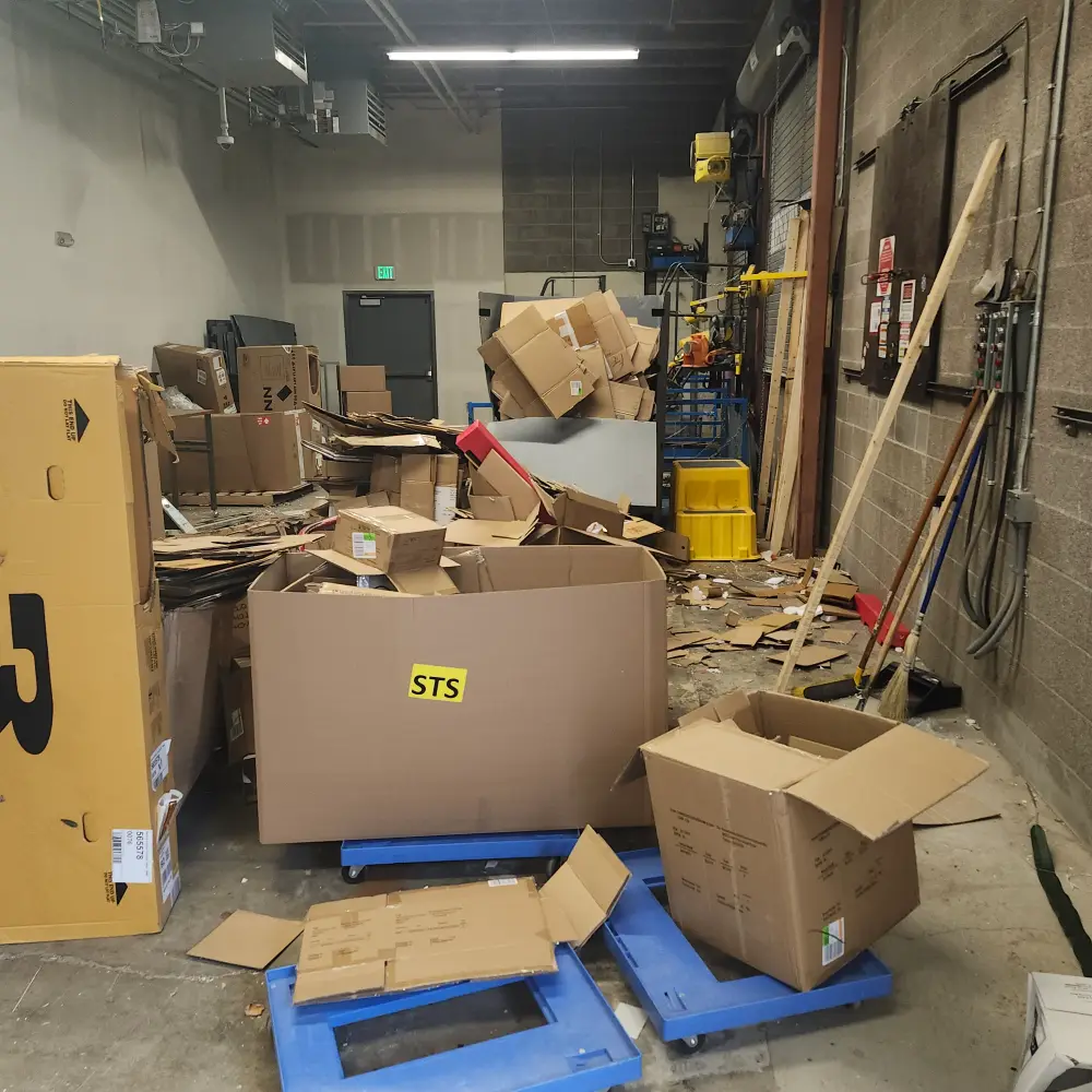 Commercial warehouse with packaging debris before a business cleanout in the Salem area