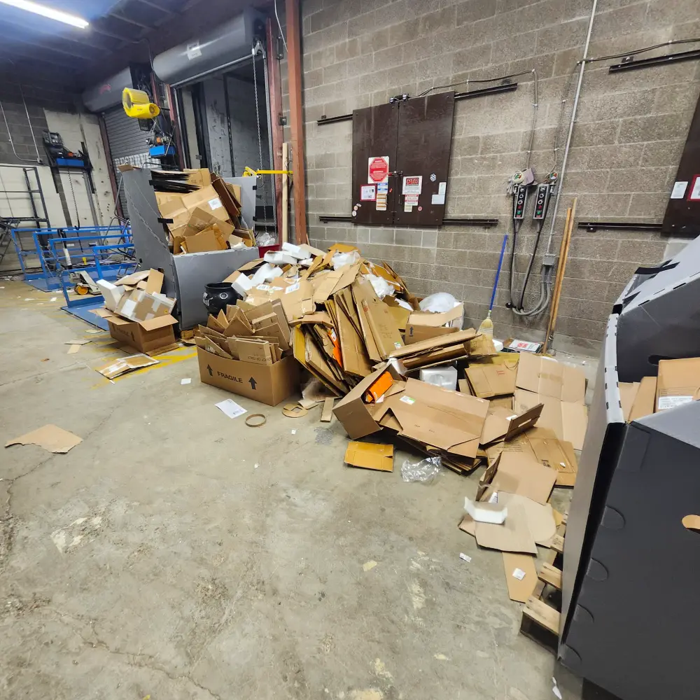 Broken-down cardboard at a commercial loading dock before a Keizer business cleanout