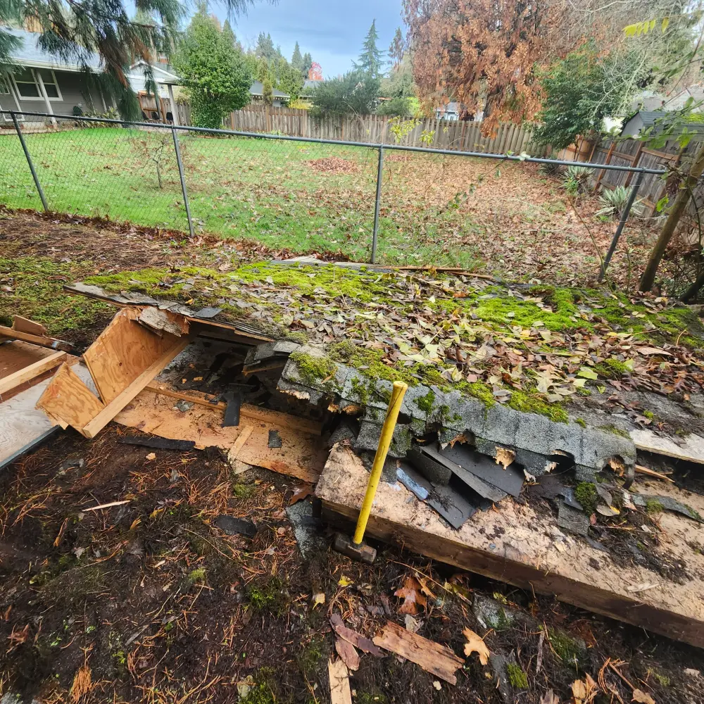 Demolished shed and fence debris cleared from a backyard in South Salem, OR