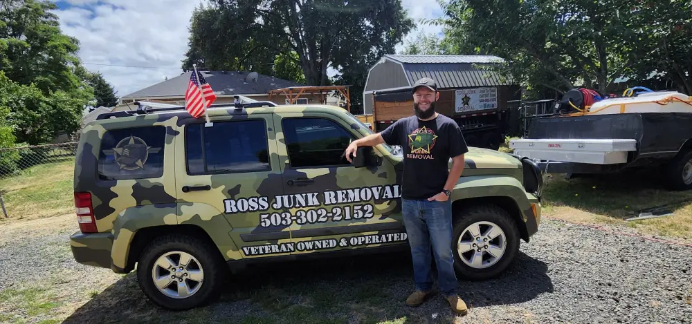 Ross, veteran owner of Ross Junk Removal, with the camo-wrapped work truck at a Glen Creek job site