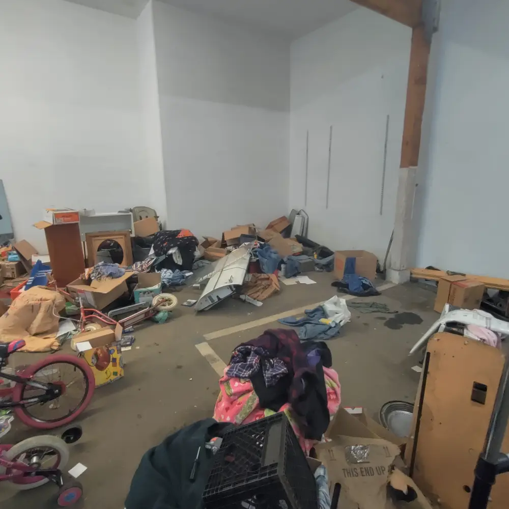 Before: a commercial building interior cluttered with junk in Salem, OR