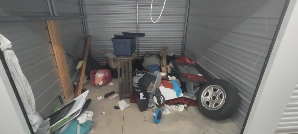 Storage unit cleanout with bins and scattered items in Orchard Heights, OR