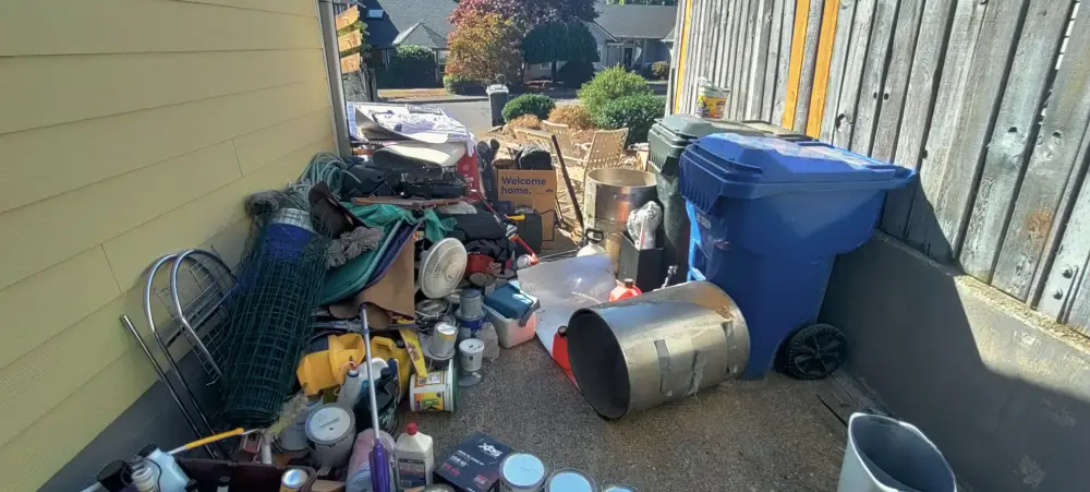 Side yard cleared of junk, tools, and paint cans from a Glen Creek, OR property