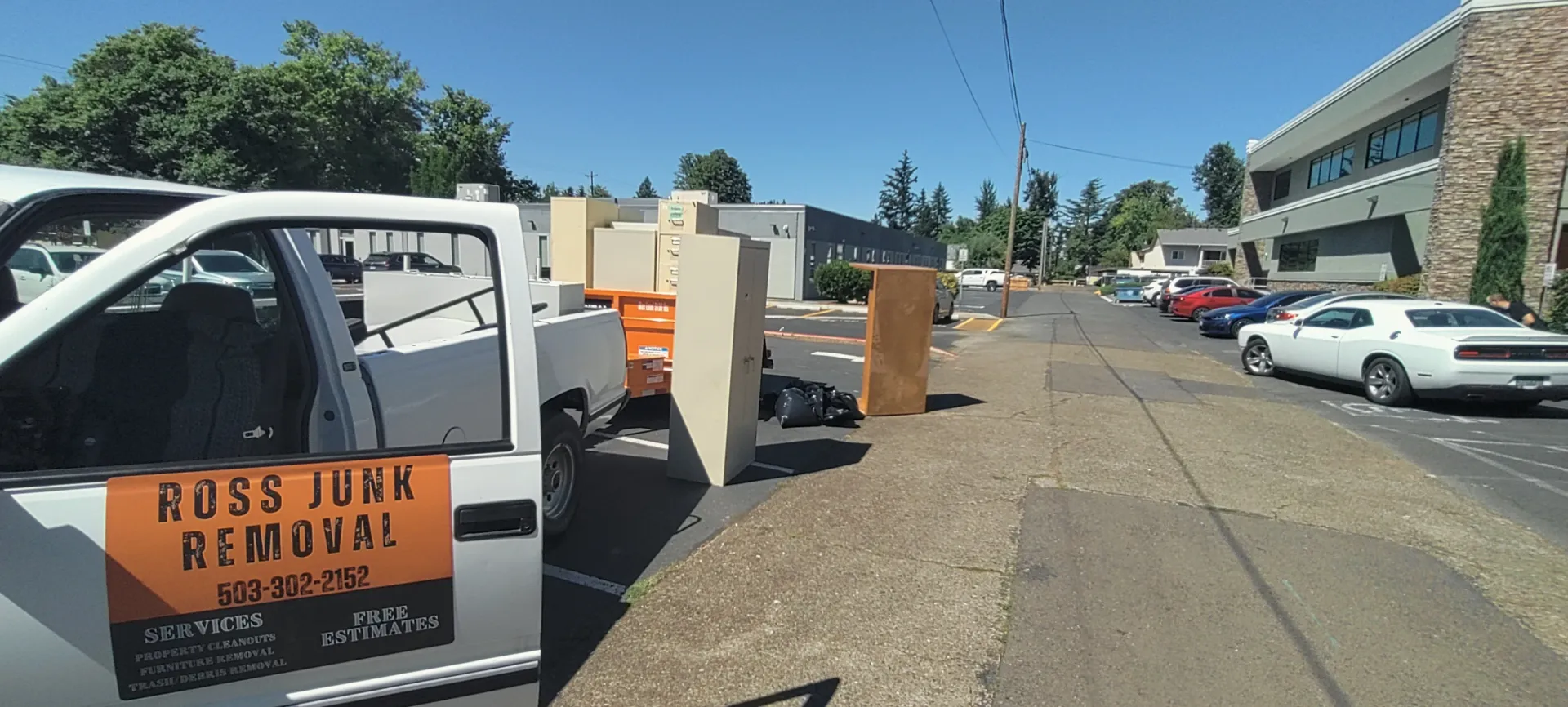 Ross Junk Removal branded truck with furniture staged for pickup on a Salem, Oregon street